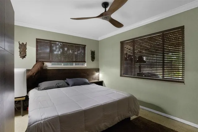 a bedroom with a large bed and a window