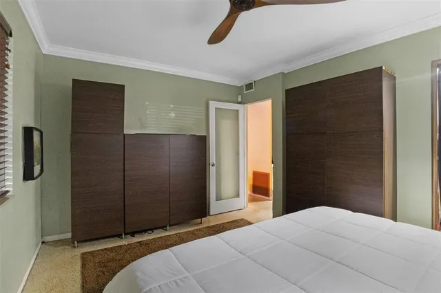 a bedroom with a bed and a mirror