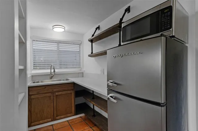 a kitchen with a refrigerator and a sink