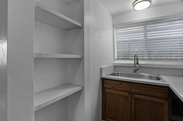 a kitchen with a sink and a window