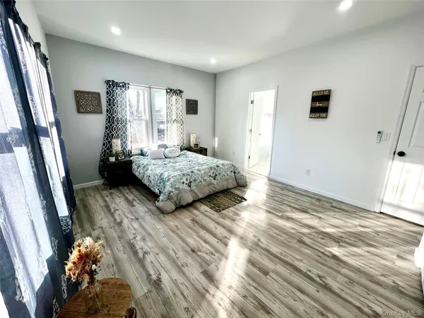 a bedroom with a bed and a large window