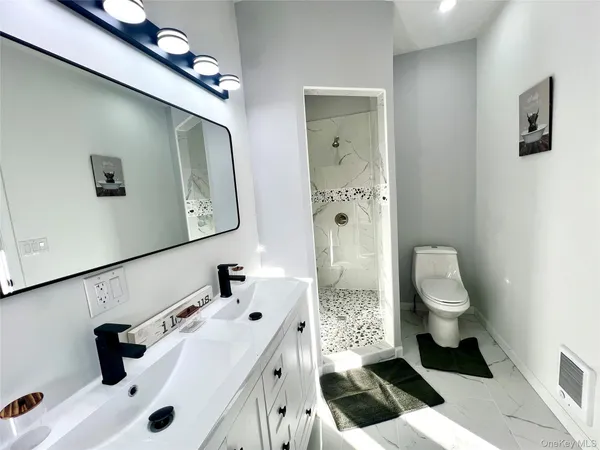 a bathroom with a sink a toilet and a mirror