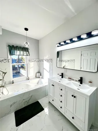 a bathroom with a double vanity sink mirror and