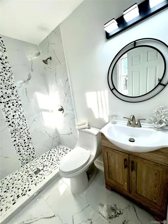 a bathroom with a sink toilet and shower