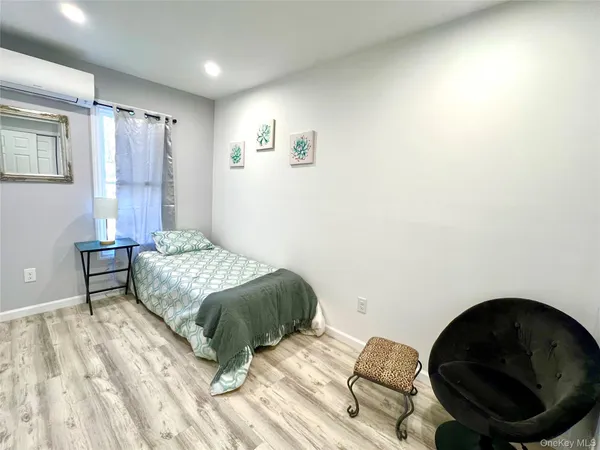 a bedroom with a bed and a chair