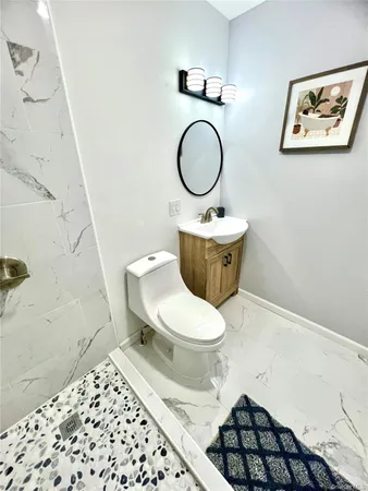 a white toilet sitting next to a small bathroom