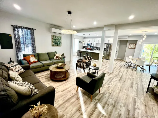 a living room with furniture or kitchen view and a wooden floor