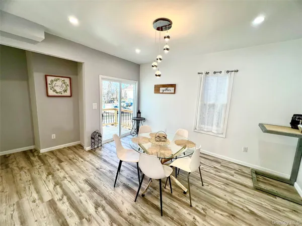 a view of a livingroom with furniture window and wooden floor