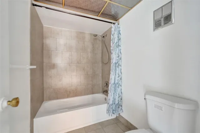 a bathroom with a shower and a toilet
