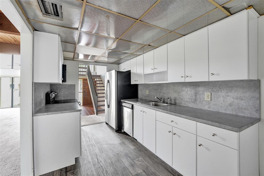 750 East Coco Plum Circle, Unit 2 Plantation, FL 33324 - Photo 6 of 21 a kitchen with stainless steel appliances granite countertop a refrigerator a stove and white cabinets
