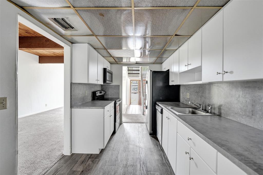 750 East Coco Plum Circle, Unit 2 Plantation, FL 33324 - Photo 7 of 21 a kitchen with stainless steel appliances granite countertop a sink a stove and cabinets