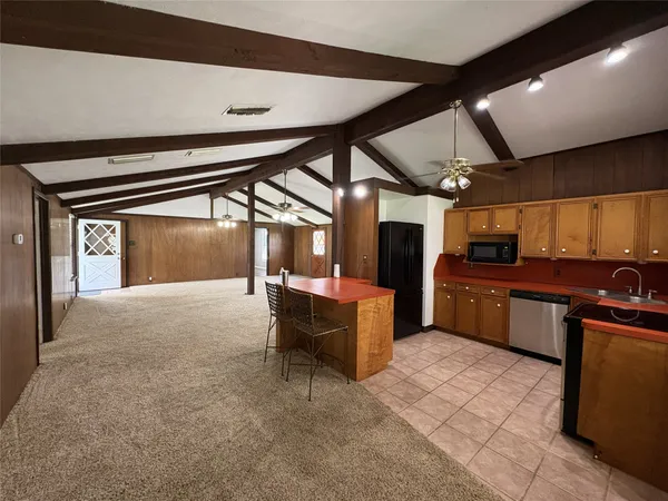 a kitchen with stainless steel appliances wooden cabinets and a stove top oven