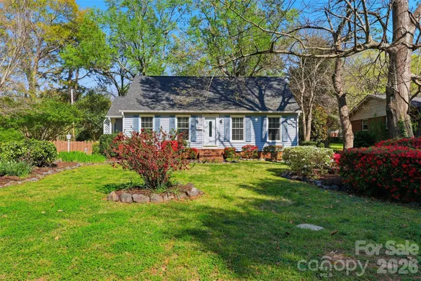 a front view of a house with a garden and plants
