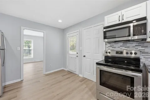 a kitchen with a stove and a microwave
