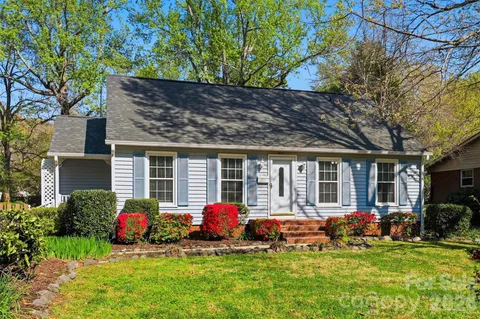 a front view of a house with a porch and garden