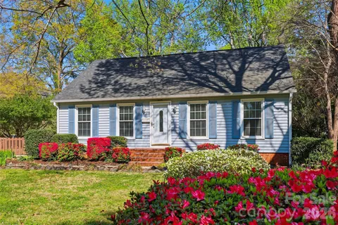 a front view of a house with a porch and garden