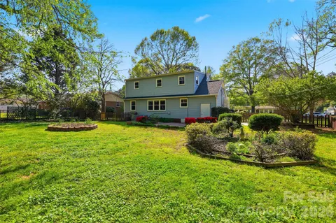 a front view of a house with a yard table and chairs