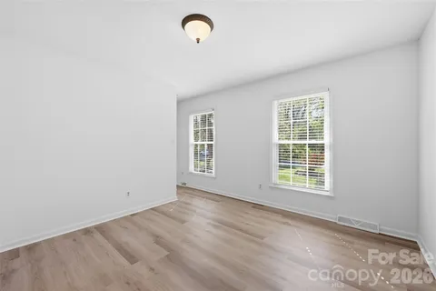 an empty room with a empty space and windows