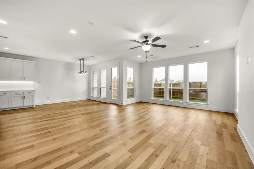 Wood-finish flooring, recessed lighting, and a ceiling fan