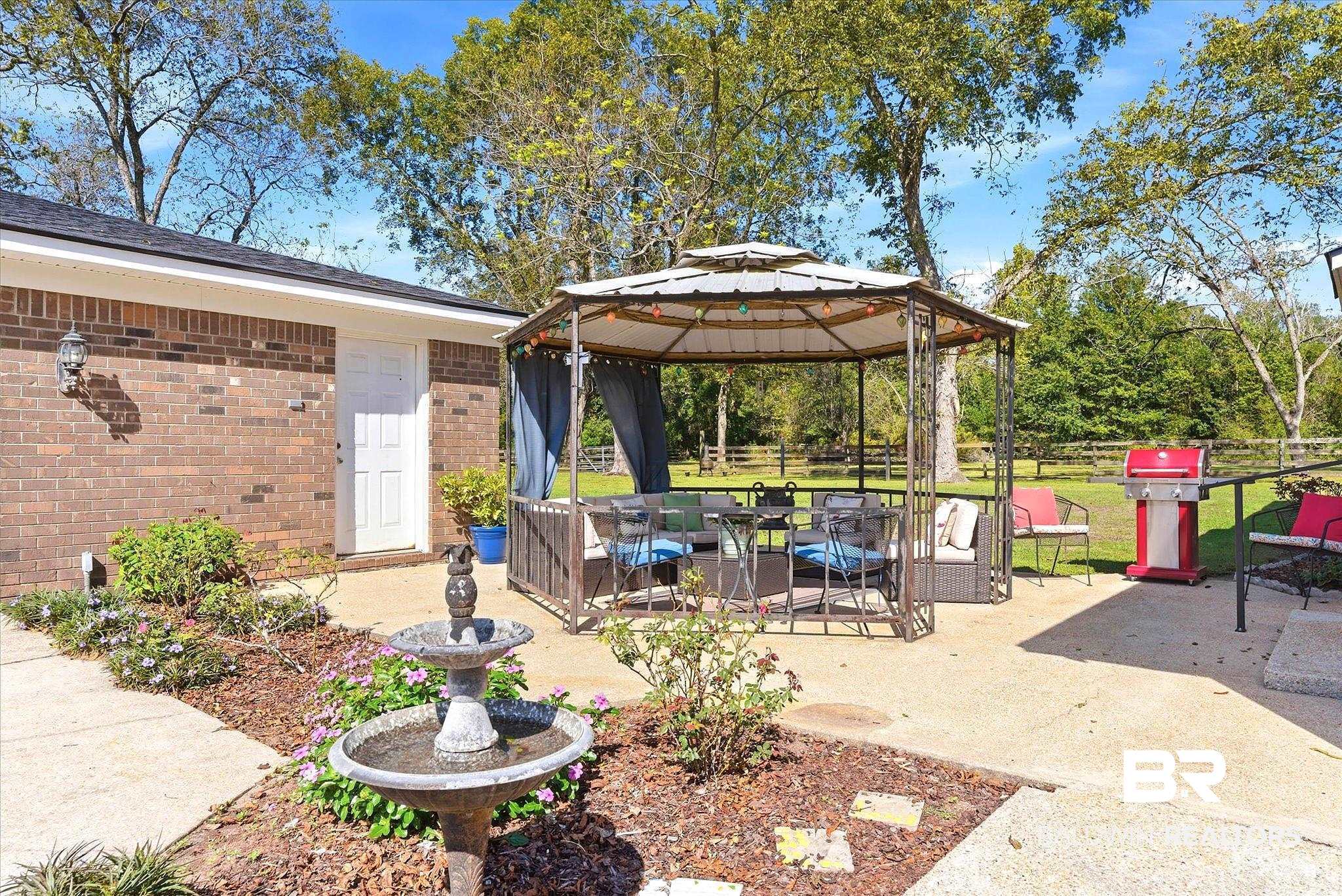 8090 Murray Hill Road Irvington, AL 36544 - Photo 29 of 40 View of patio with a gazebo and outdoor seating