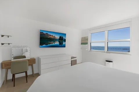 a bedroom with a bed and a chair