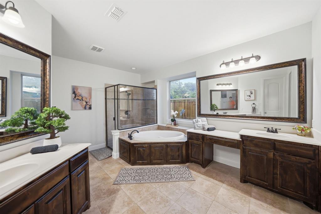 624 Sorrell Road McKinney, TX 75072 - Photo 13 of 28 a spacious bathroom with a granite countertop sink and a mirror