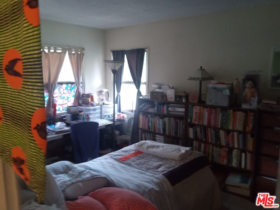 5832 Bowcroft Street, Unit 4 Los Angeles, CA 90016 - Photo 12 of 34 a bed room with furniture and a window