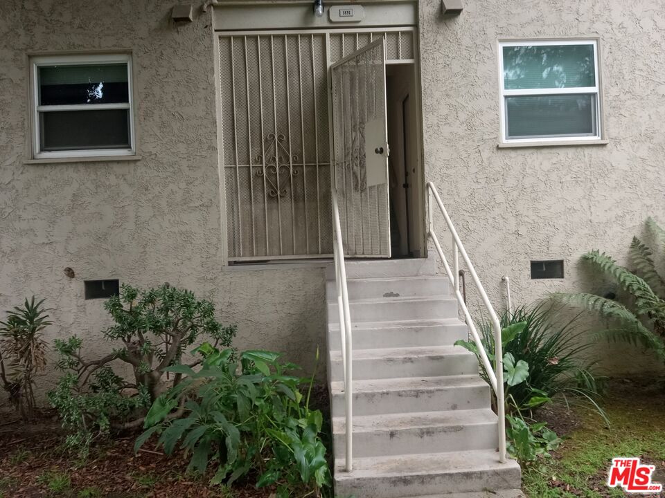 5832 Bowcroft Street, Unit 4 Los Angeles, CA 90016 - Photo 16 of 34 a view of staircase with white walls and a potted plant