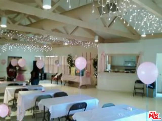 an aerial view of a house with a garden and trees