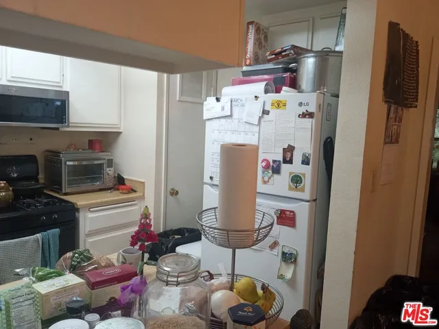 a kitchen with stainless steel appliances a refrigerator and a stove top oven