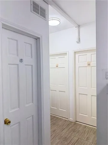 a view of hallway with a furniture and a refrigerator