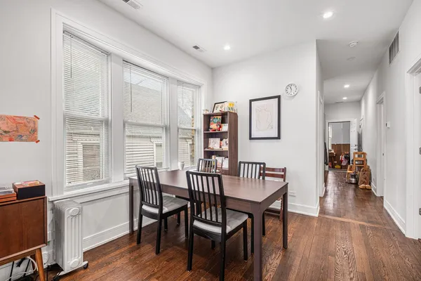 a view of a dining room with furniture and wooden floor