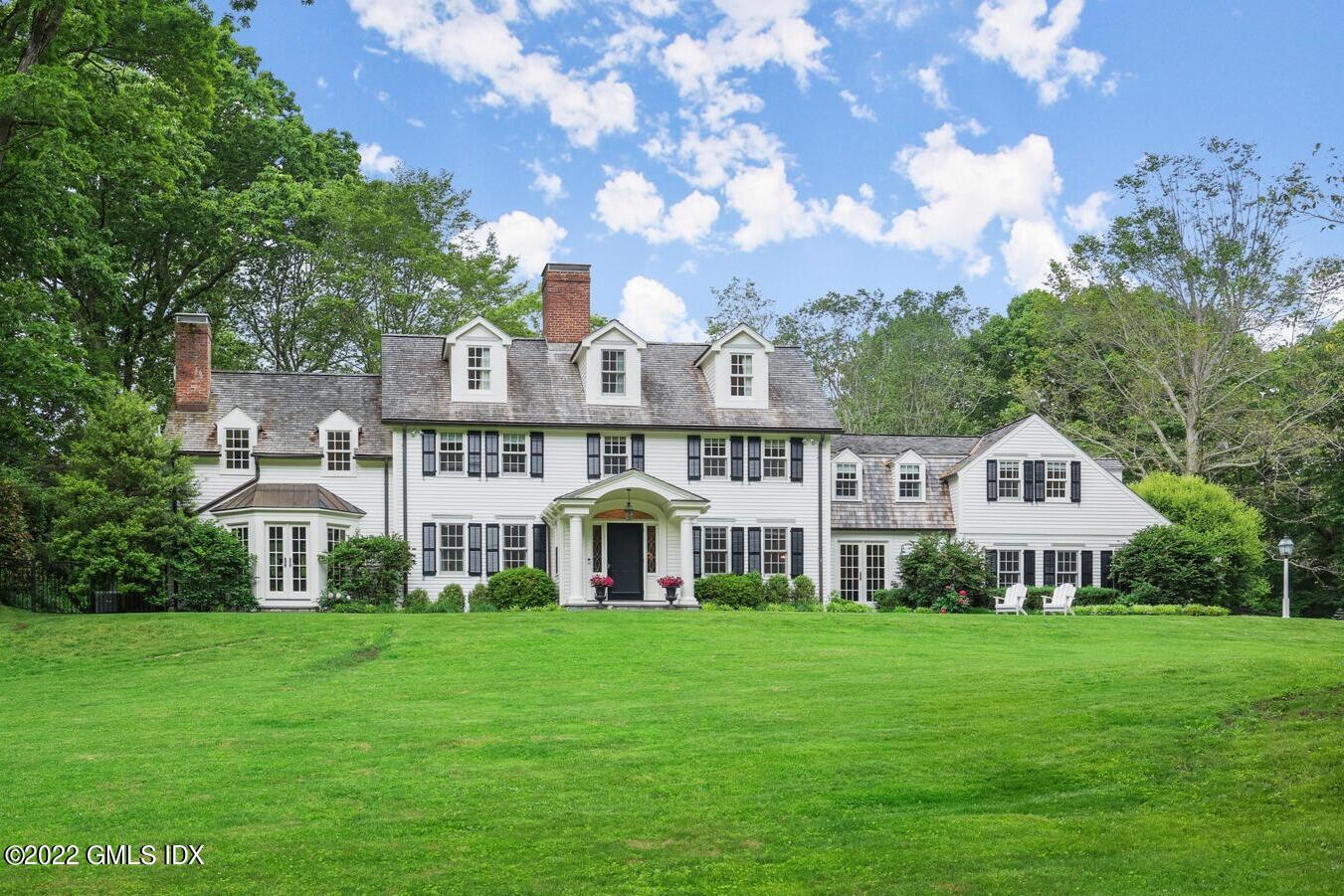 1 Lafrentz Road Greenwich, CT 06831 - Photo 1 of 1 a front view of a house with garden and trees
