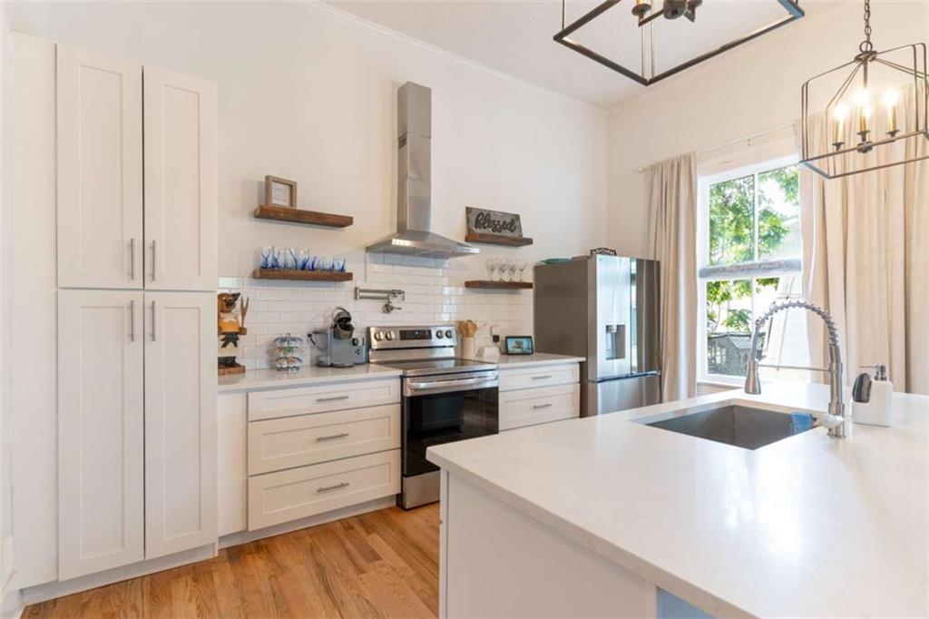 2173 Anderson Avenue Northeast Covington, GA 30014 - Photo 15 of 49 a kitchen with stainless steel appliances a sink a stove a refrigerator and cabinets