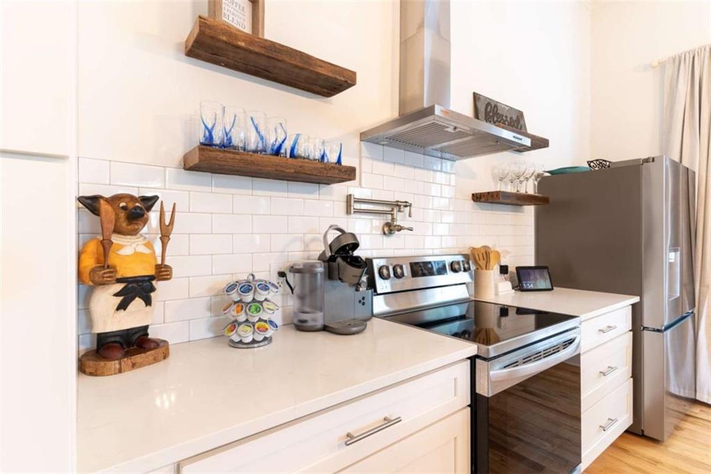 2173 Anderson Avenue Northeast Covington, GA 30014 - Photo 16 of 49 a kitchen with a sink and a stove with white countertops