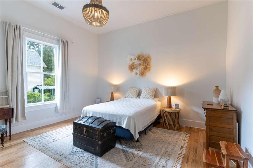 2173 Anderson Avenue Northeast Covington, GA 30014 - Photo 19 of 49 a bedroom with a bed and a chandelier