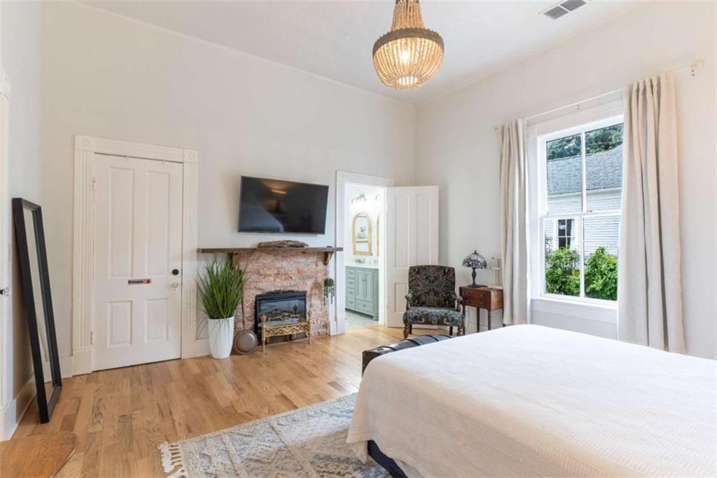 2173 Anderson Avenue Northeast Covington, GA 30014 - Photo 23 of 49 a bedroom with a bed and a flat tv screen on the dresser