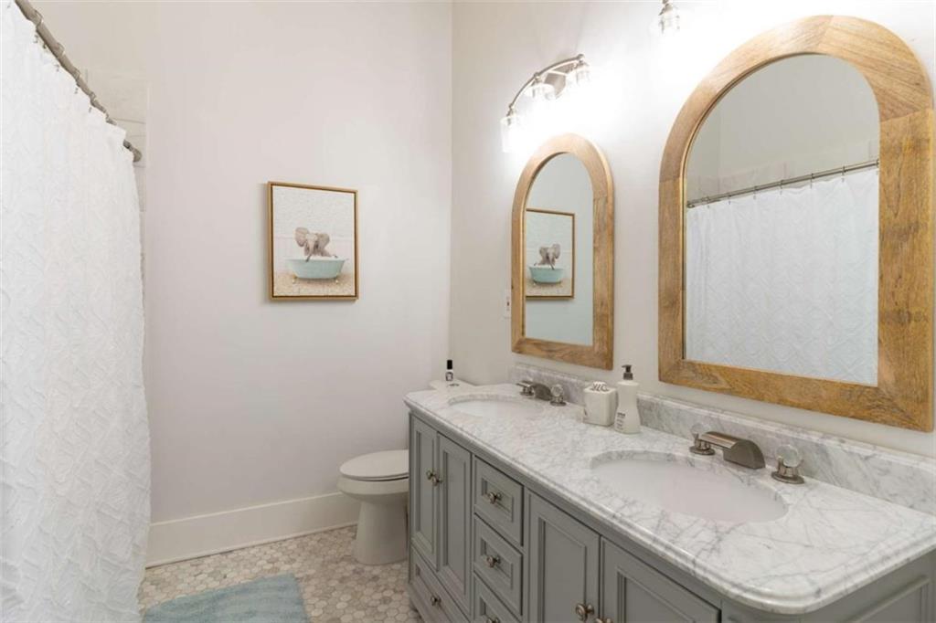 2173 Anderson Avenue Northeast Covington, GA 30014 - Photo 24 of 49 a bathroom with a granite countertop sink a toilet and a mirror