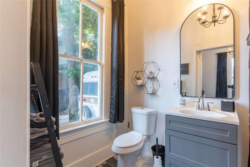 2173 Anderson Avenue Northeast Covington, GA 30014 - Photo 37 of 49 a bathroom with a toilet a sink and a window