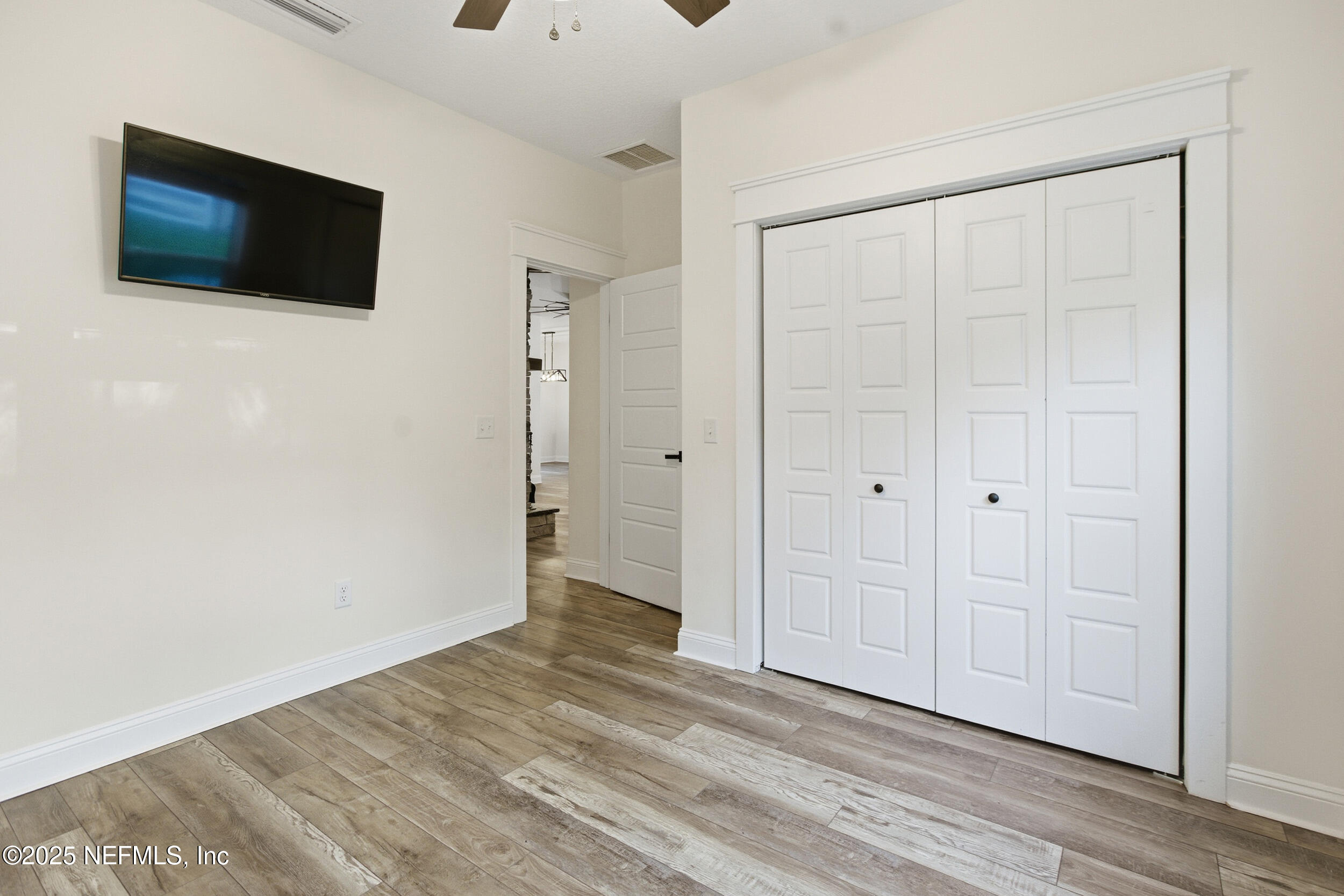 128 Santa Rosa Street Florahome, FL 32140 - Photo 13 of 57 a view of a livingroom with an empty space & wooden floor