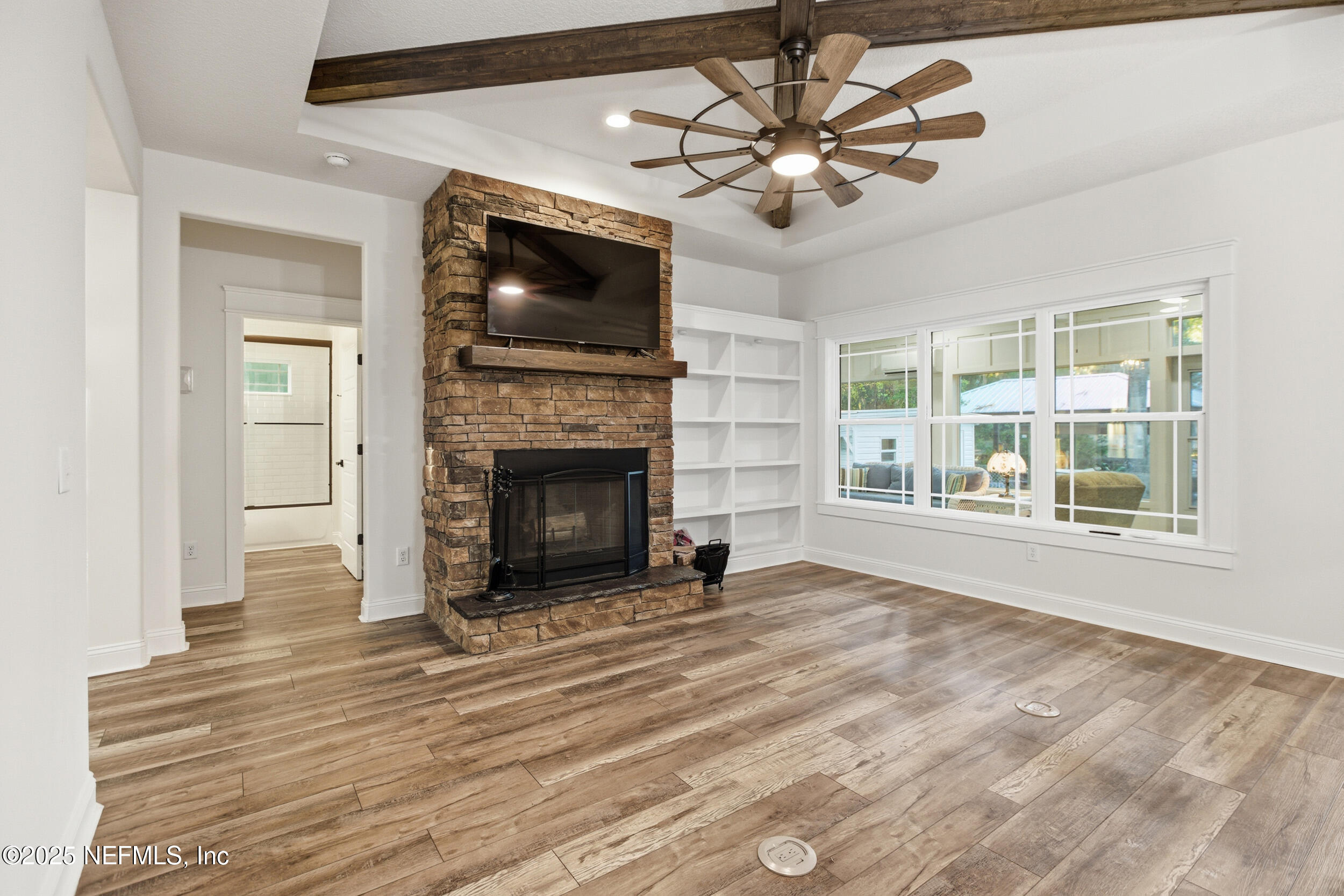 128 Santa Rosa Street Florahome, FL 32140 - Photo 15 of 57 a view of an empty room with a fireplace and a window