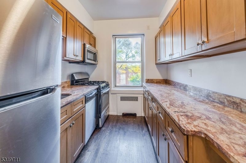 10 North Ridgewood Road, Unit 415 South Orange, NJ 07079 - Photo 2 of 5 a kitchen with granite countertop a stove and a sink