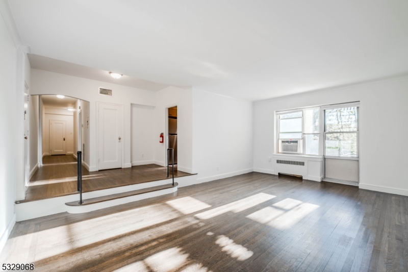 10 North Ridgewood Road, Unit 415 South Orange, NJ 07079 - Photo 3 of 5 a view of an empty room with a window and wooden floor