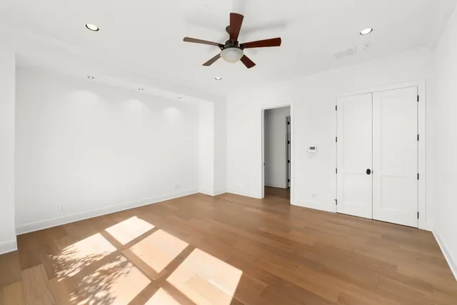 a spacious bathroom with a double vanity sink large mirror and a bathtub