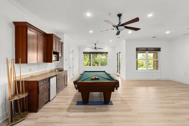an empty room with a window and a ceiling fan