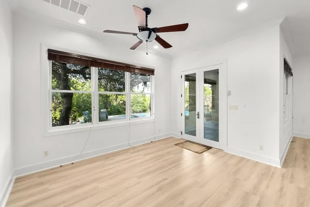 wooden floor in an empty room with a window