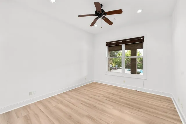 a bathroom with a granite countertop toilet sink and mirror