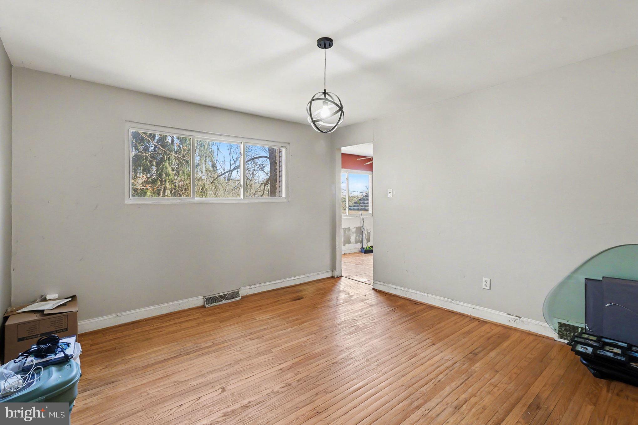 2338 Fairway Road Huntingdon Valley, PA 19006 - Photo 13 of 27 a view of an empty room with wooden floor and a window