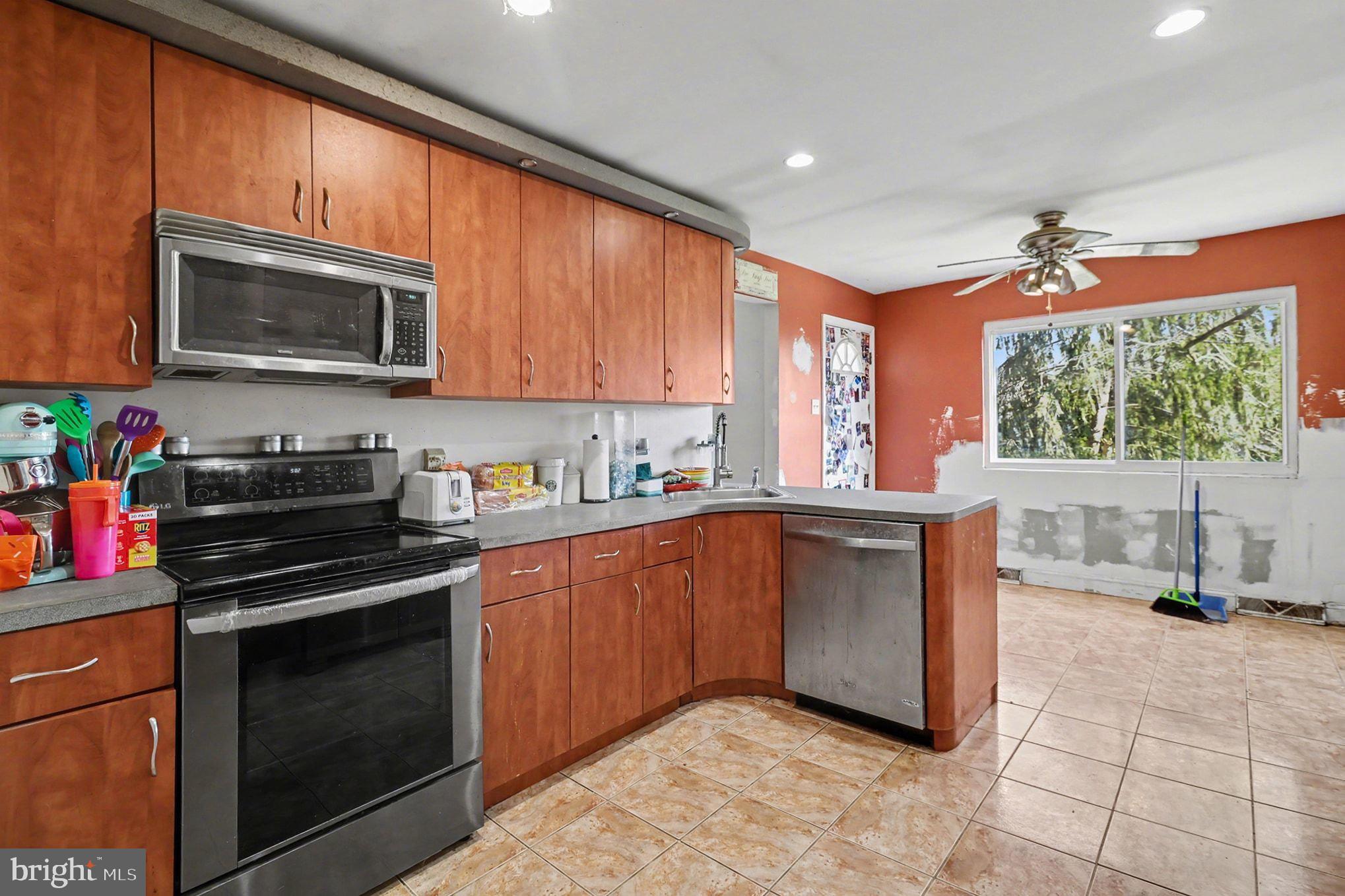 2338 Fairway Road Huntingdon Valley, PA 19006 - Photo 7 of 27 a kitchen with stainless steel appliances granite countertop a stove a sink and a microwave