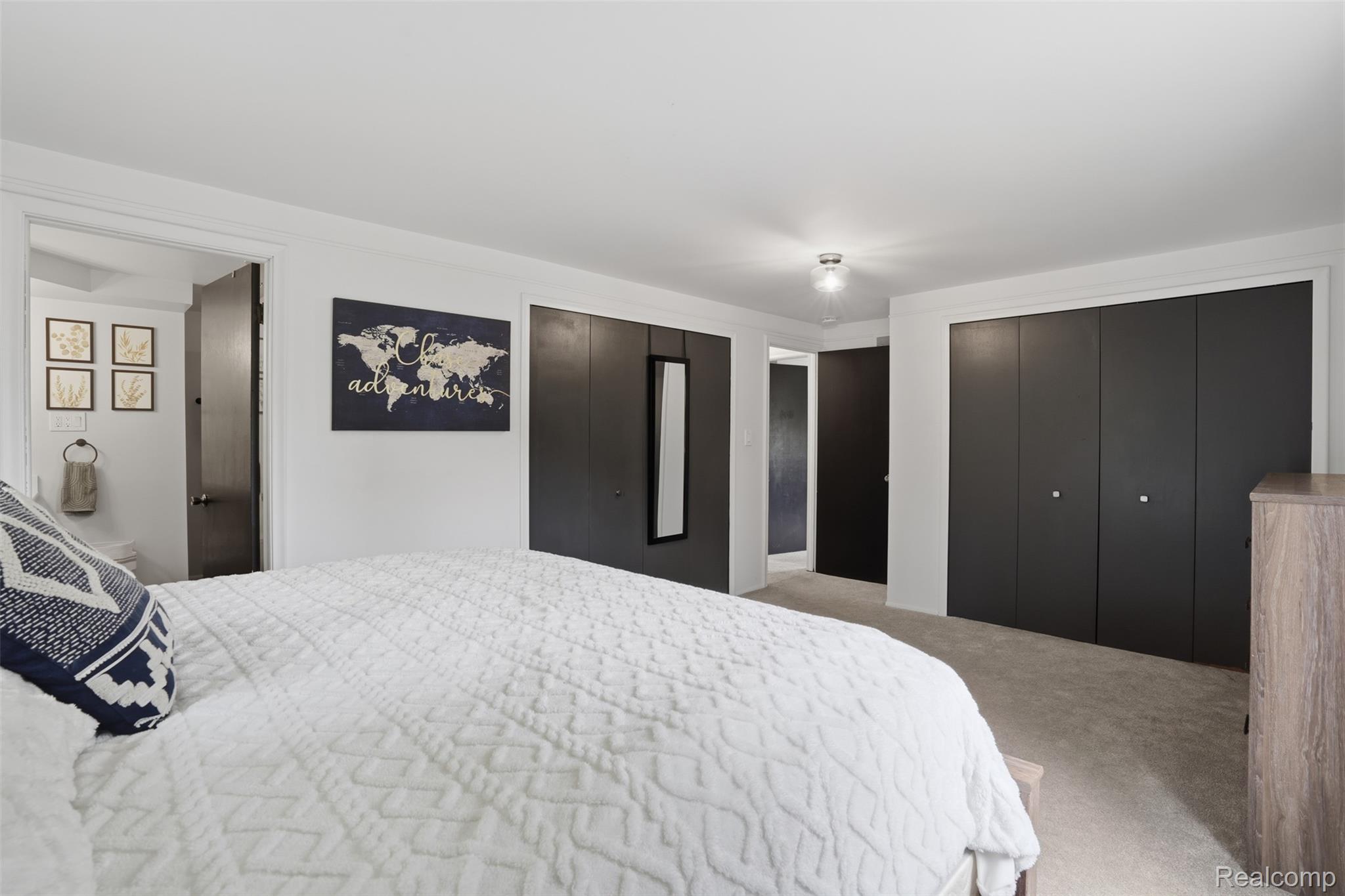 47129 Dunsany Road Northville, MI 48167 - Photo 21 of 49 Bedroom featuring two closets, light carpet, and ensuite bathroom